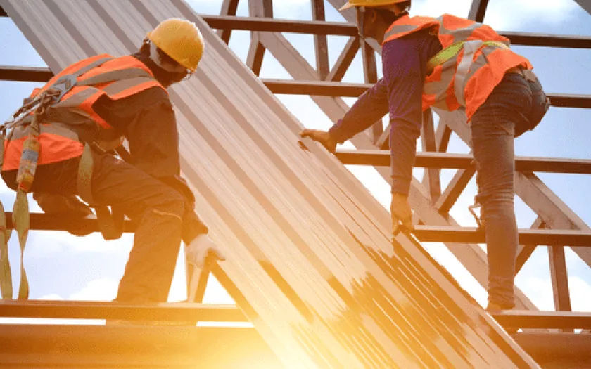 Construction workers framing a roof